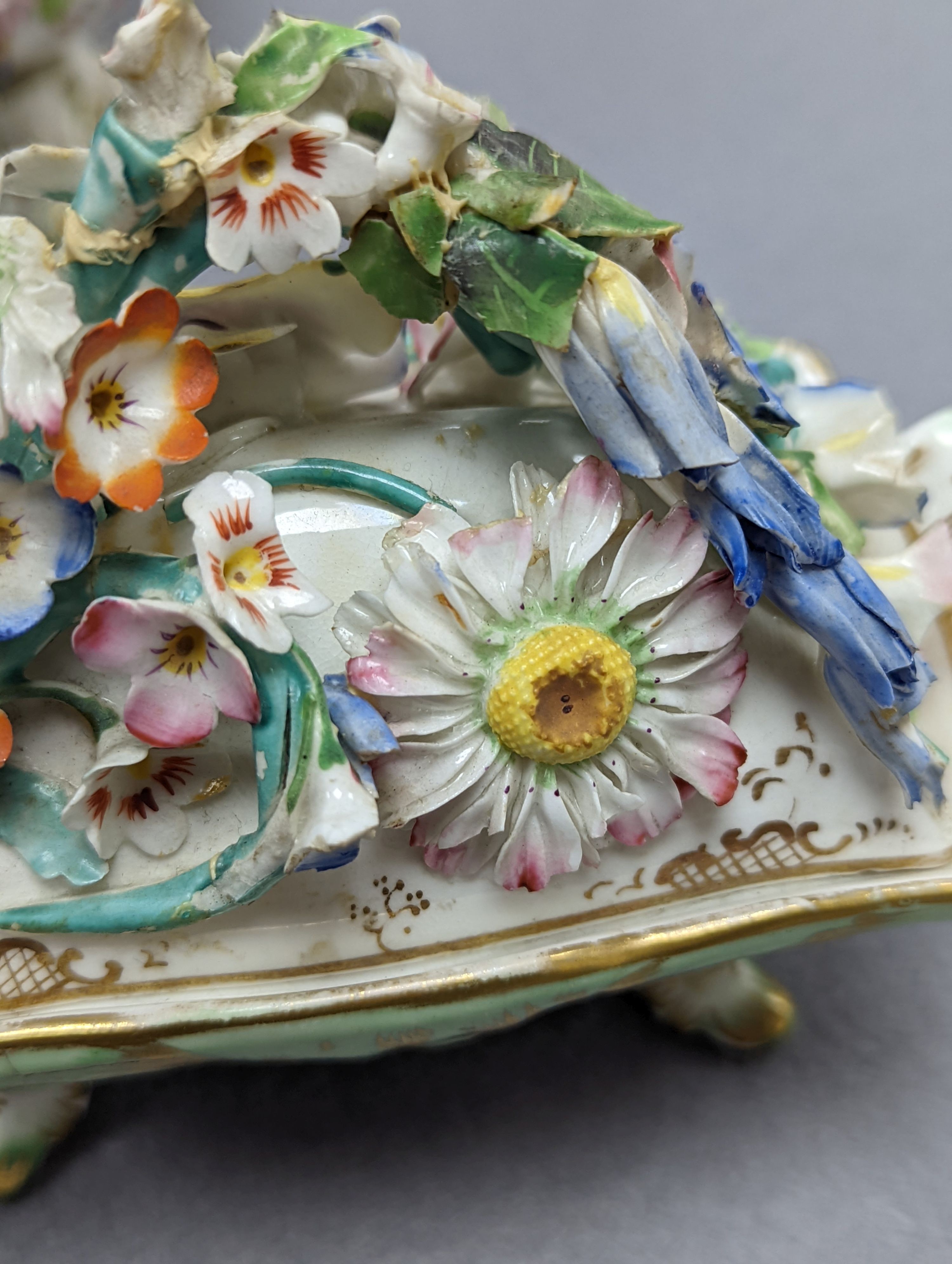 An 18th century Mennecy porcelain cup and cover, a Meissen style cup and cover, an English porcelain floral encrusted double inkwell and cover and a similar jar and cover